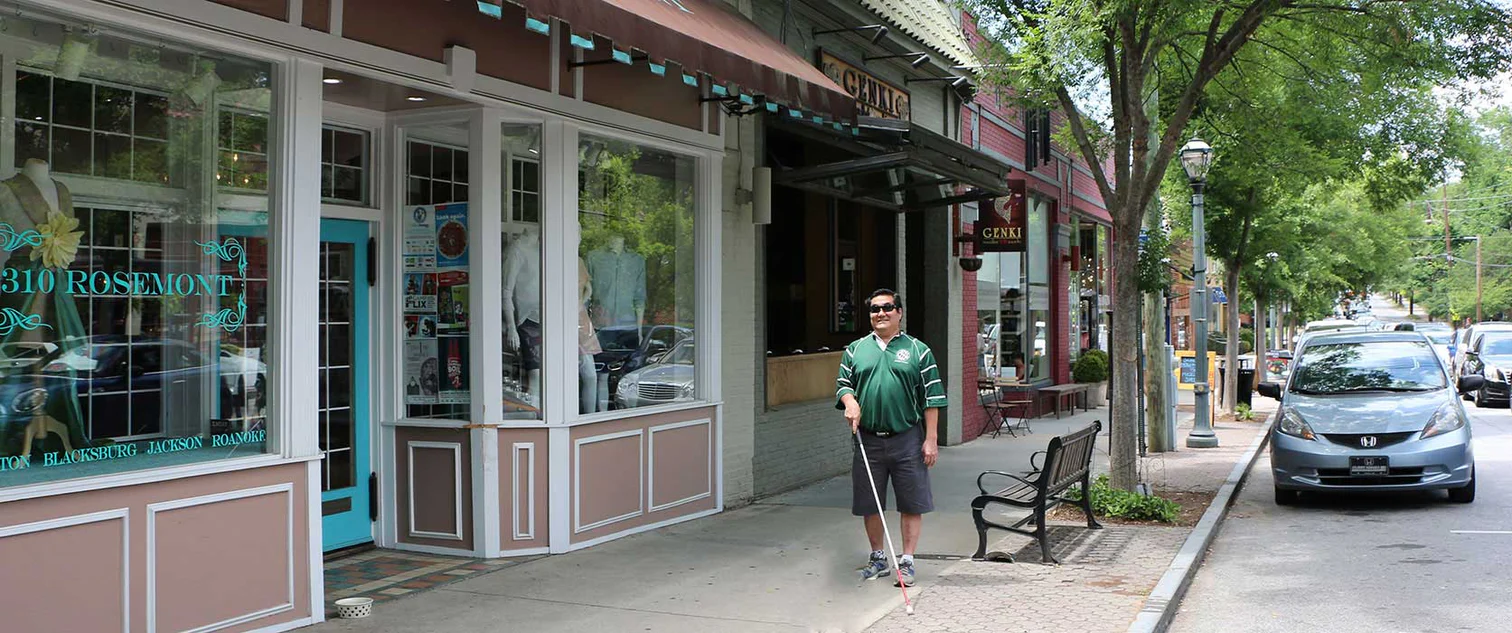 Dave walking downtown with his white cane